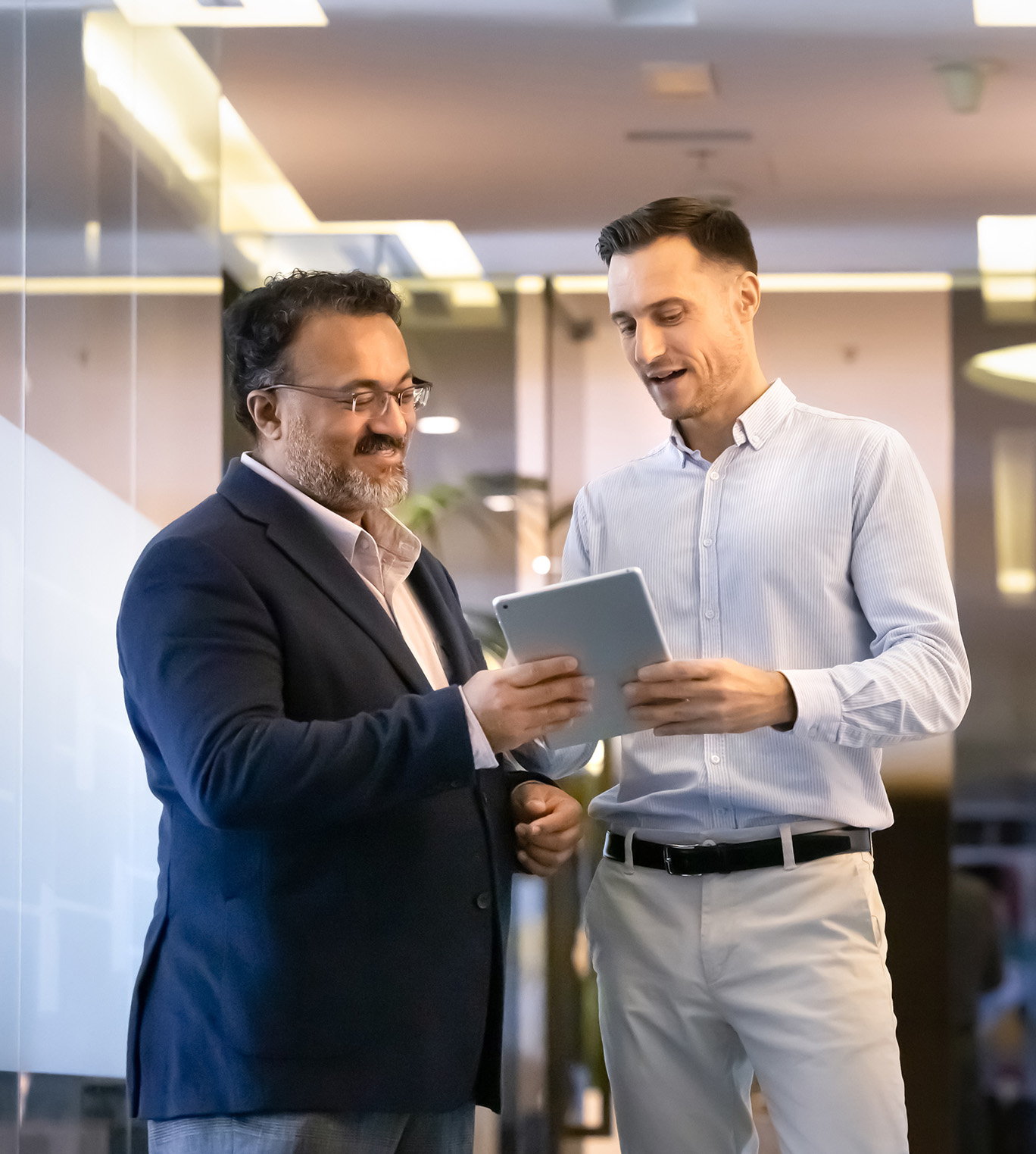 Two executives discuss software readiness on a tablet